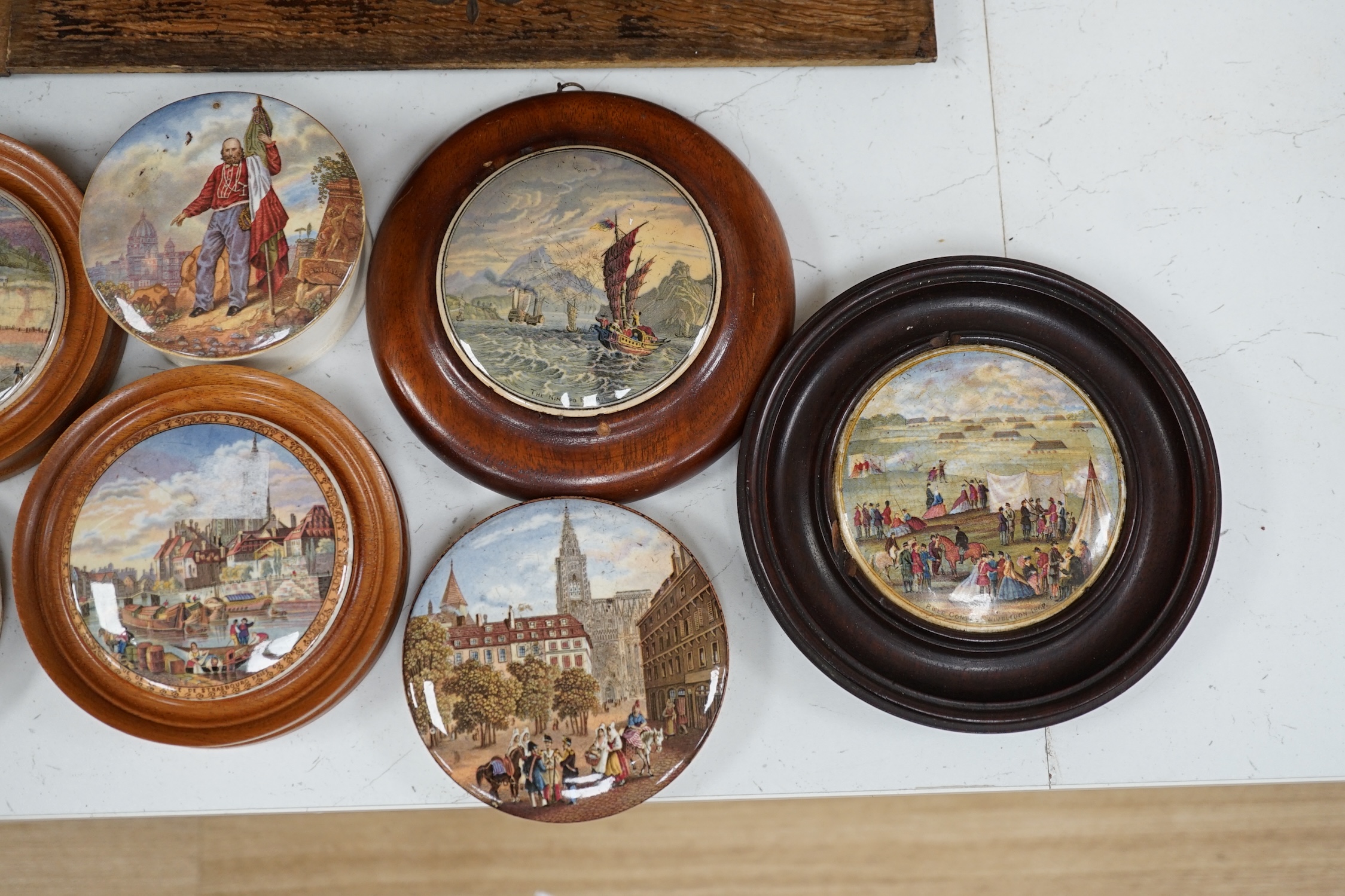 Eleven 19th century mostly framed pot lids including ‘The Ning Po River’, ‘Rifle Contest Wimbledon 1868’, ‘Vue De La Ville De Strasbourg Prise De Port’ etc. Condition - fair to good